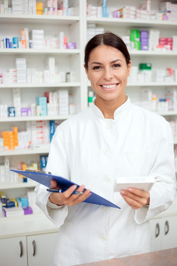 female-pharmacist-smiling-shelving